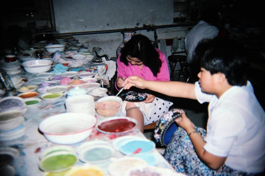 Dated 1991 slide of workers applying enamel material to cloisonné vessels