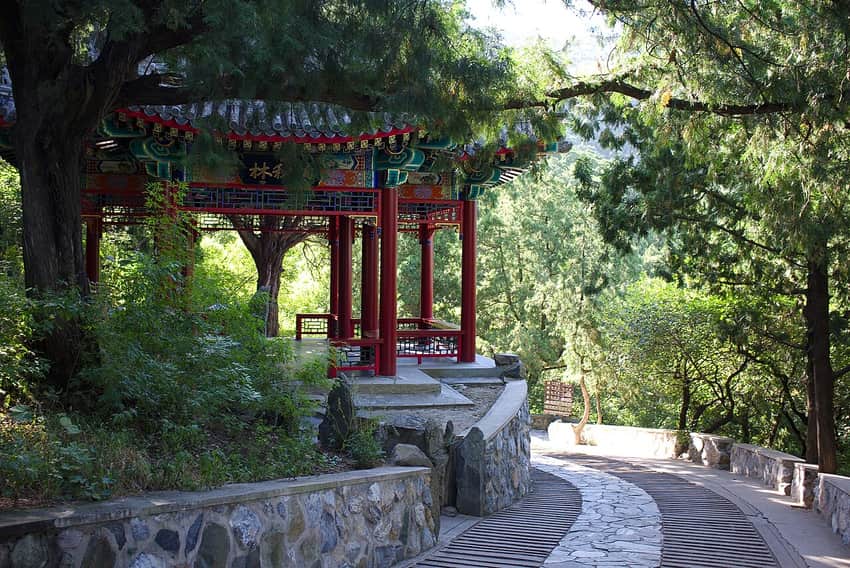 Winding shaded stone path and pavilion at Fragrant Hills Park