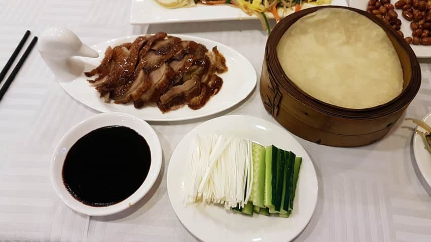 Sliced Beijing roast duck served with wrappers and accompaniments