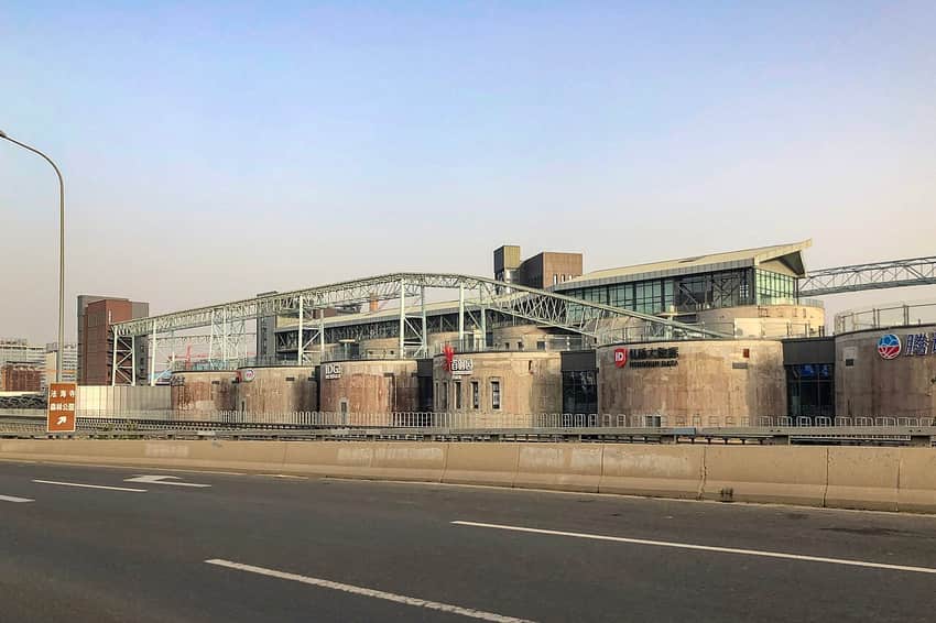 Dated street-side view of retained and adapted industrial structures at Shougang Park