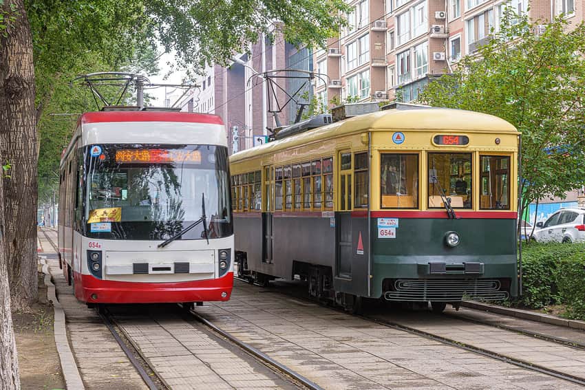 Modern and heritage-style trams passing in Changchun in 2023