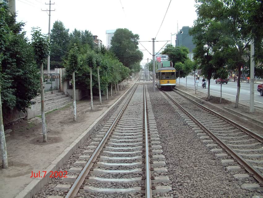 Dated July 2002 photograph of a yellow Changchun tram