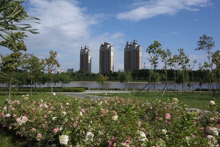 Landscaped Yitong River corridor and residential towers