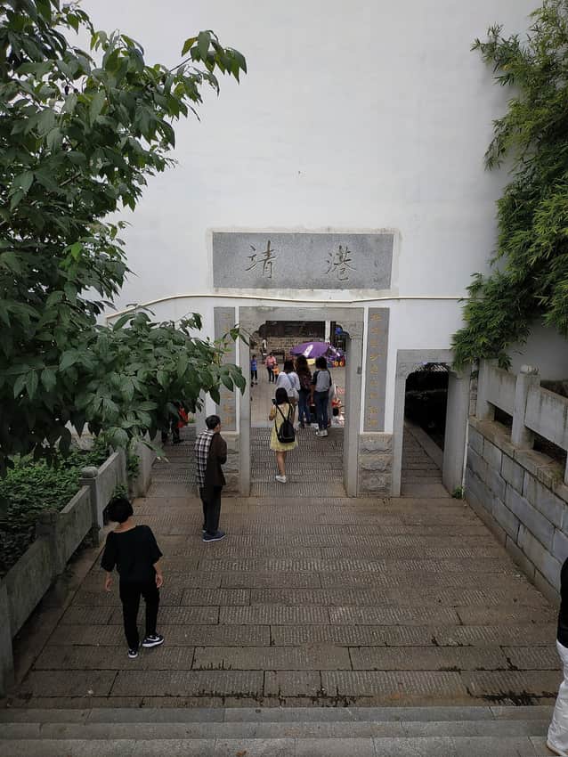 Visitors passing through a gate at Jinggang historic town