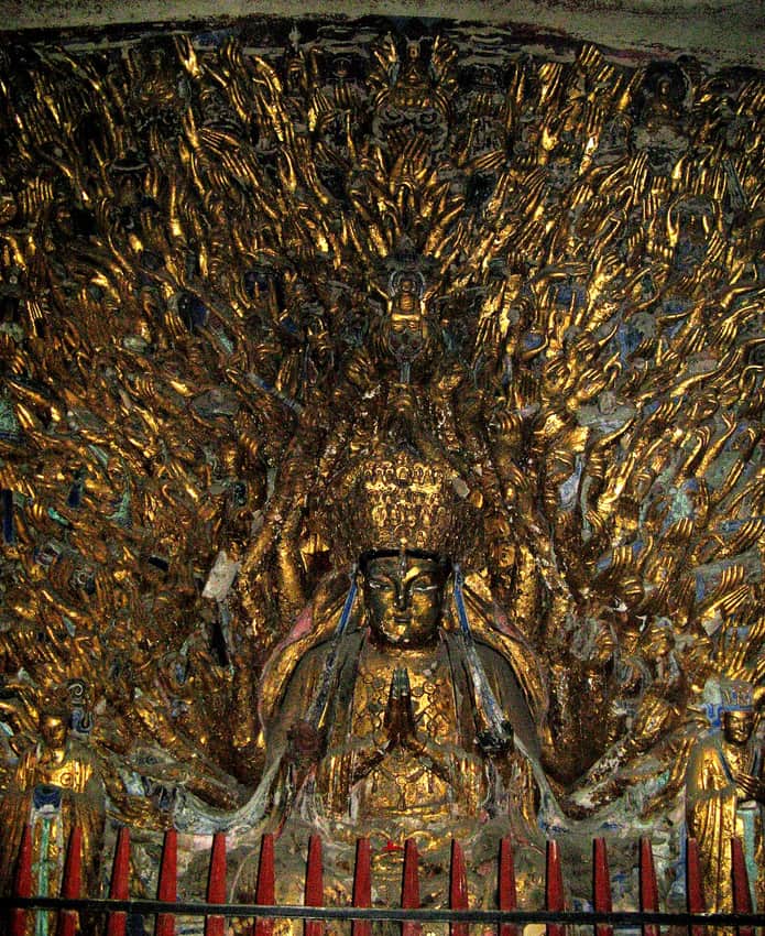 Dense carved figures in one Dazu Rock Carvings ensemble
