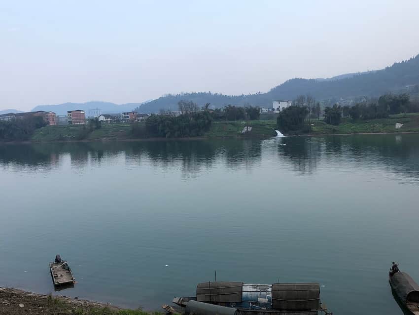 Small boats and cultivated banks along a Zhou River reach in Dachuan