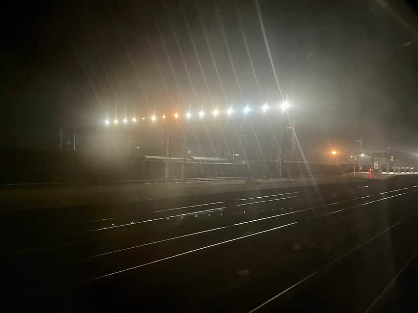 Night view across tracks and lights in Dazhou station's western yard