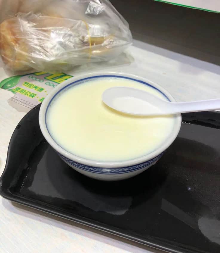 Pale milk custard in a blue-rimmed bowl