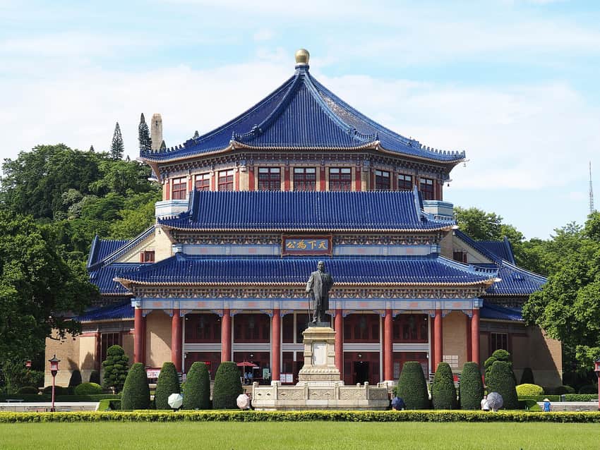 Blue-roofed octagonal memorial hall and statue