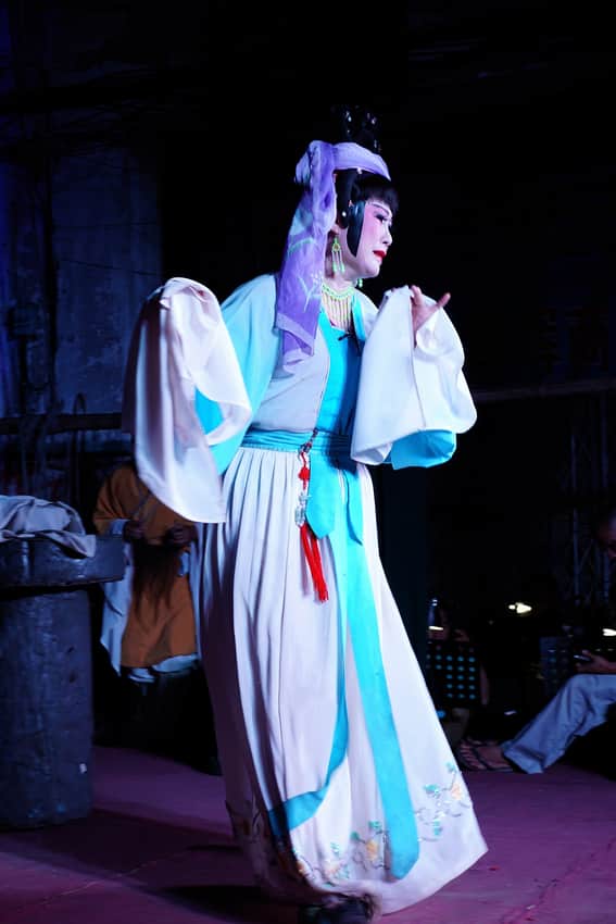 Costumed performer in a Qiong opera stage context