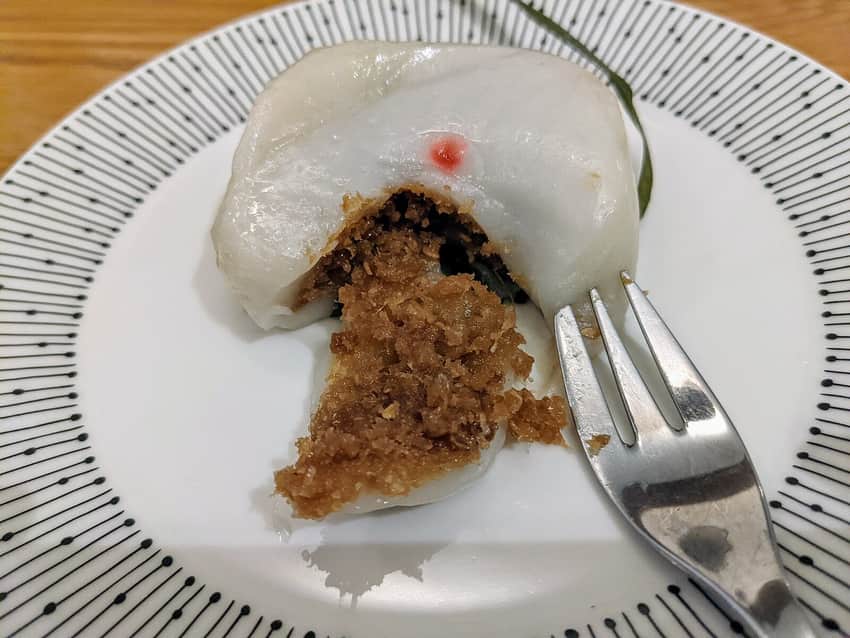 Cut-open Hainanese yi bua showing wrapper and filling