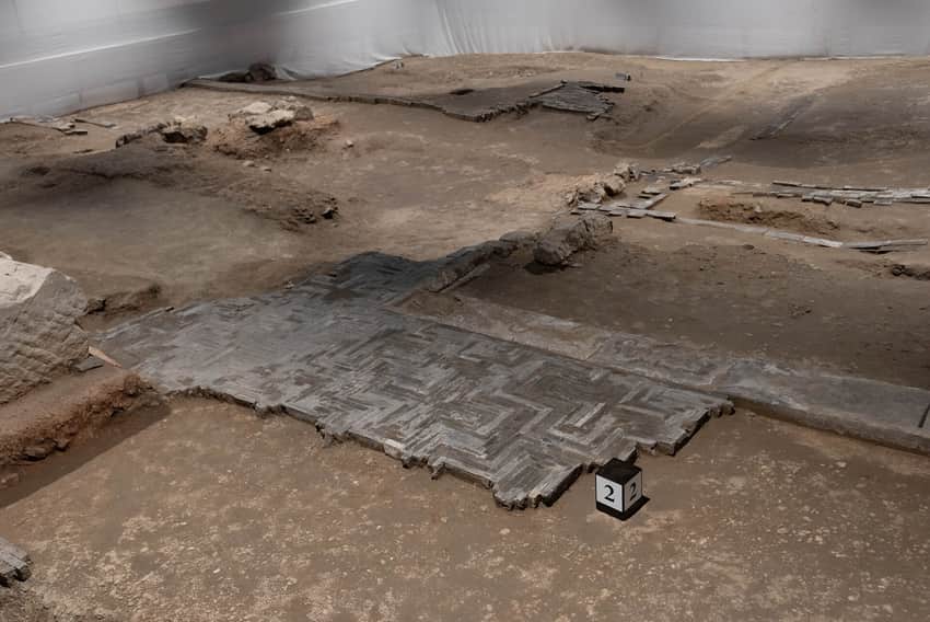 Brick archaeological remains and numbered marker inside Deshou Palace Site Museum