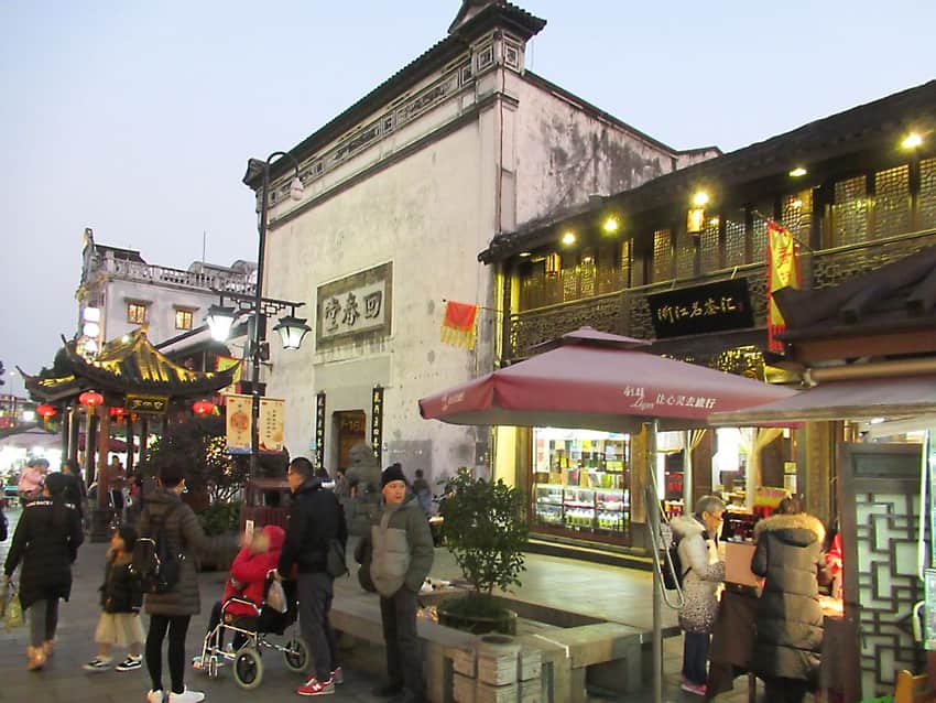 Dated evening view of Hefang Street with shops, lanterns and pedestrians