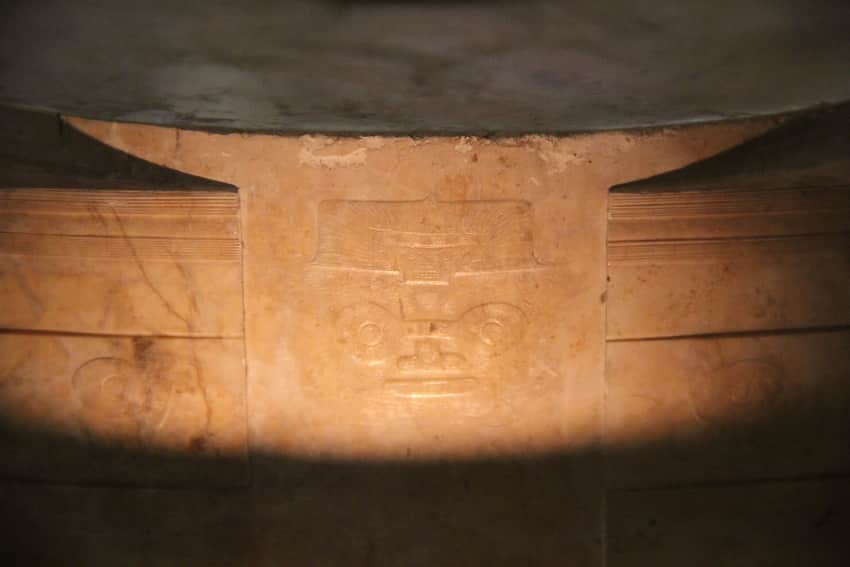 Cropped close view of a carved face motif on a Liangzhu jade cong