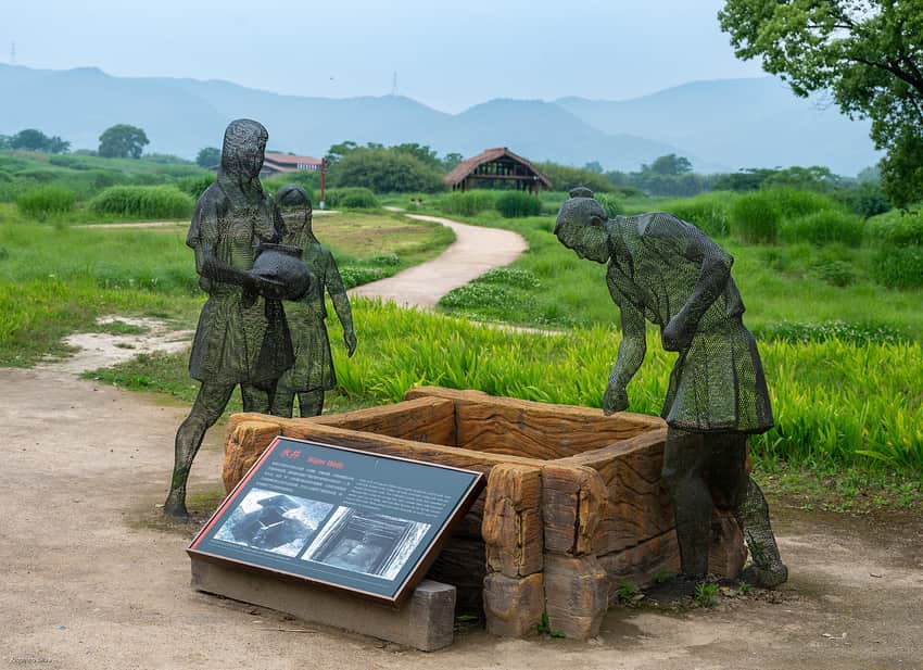 Present-day interpretive figures, recreated well and fields at Liangzhu archaeological park