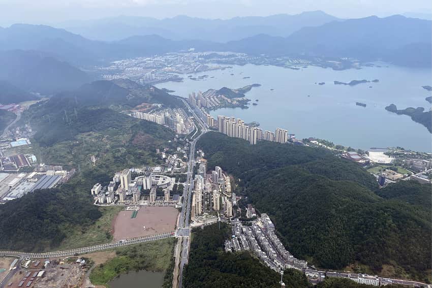 Aerial view of Chun'an county seat, forested hills and Qiandao Lake islands