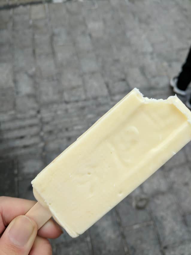Hand holding an ice-cream bar on Central Street
