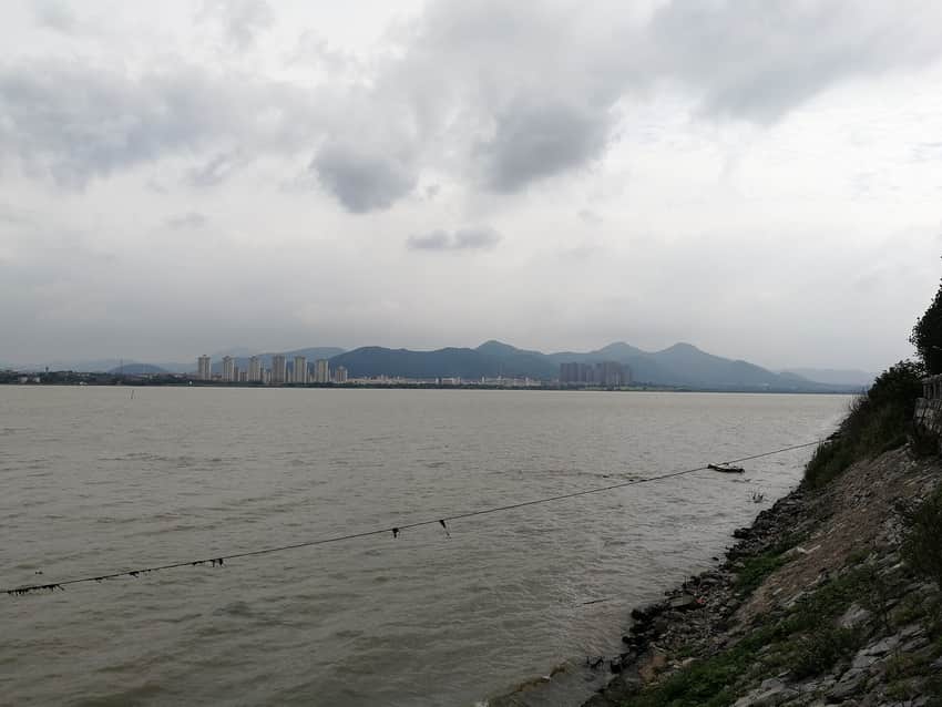 Wide 2017 landscape of Chaohu Lake, hills and a shore settlement