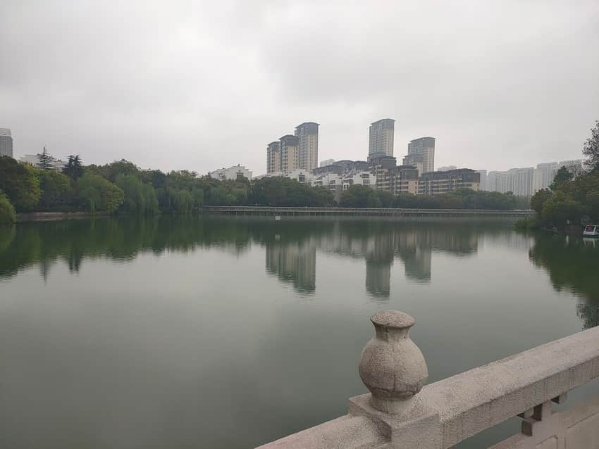 Overcast 2024 view across Yaohai Park lake toward housing