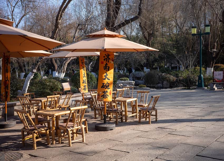 Bamboo chairs and big-bowl tea banners near Five Dragon Pool