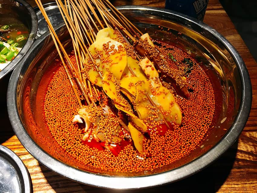 Bobo chicken skewers in red chile oil and sesame