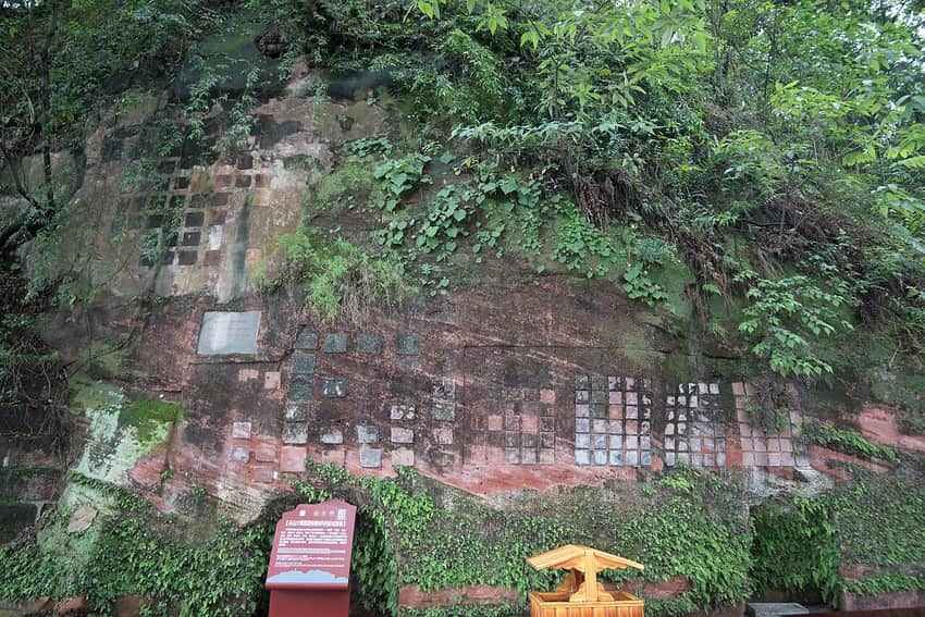 Experimental conservation patches on sandstone near Leshan Giant Buddha