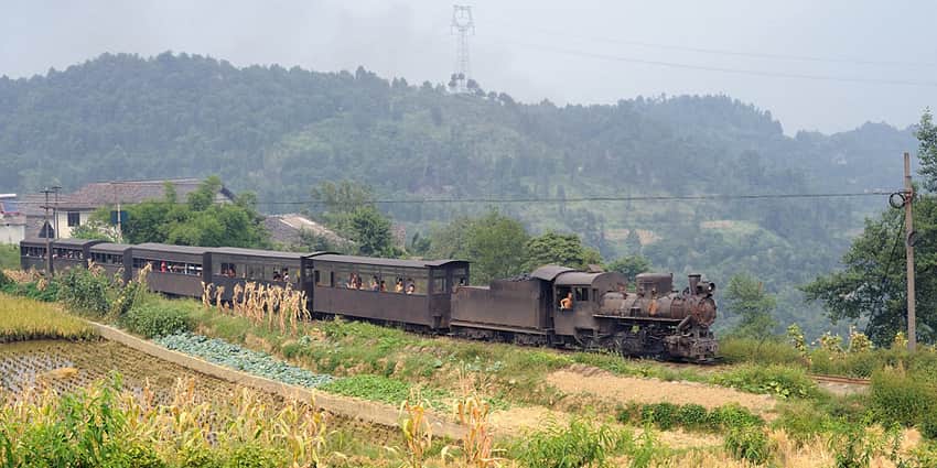 Jiayang steam train passing fields in Qianwei County