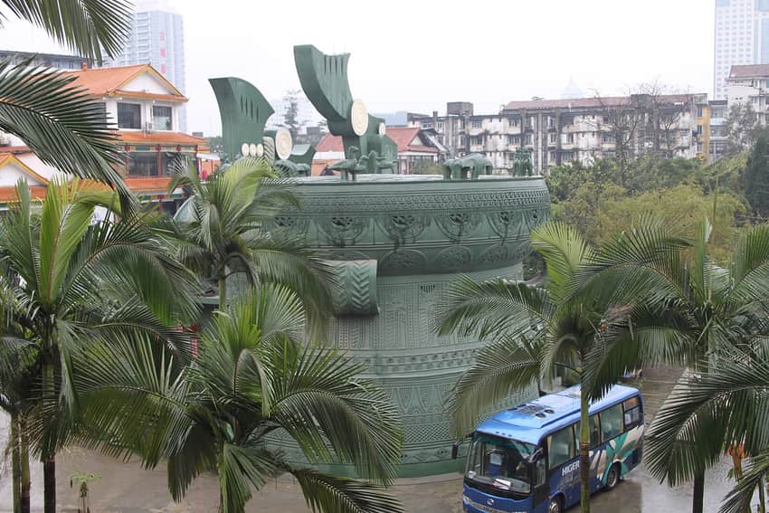 Large bronze-drum-shaped interpretation among palms at a Guangxi museum