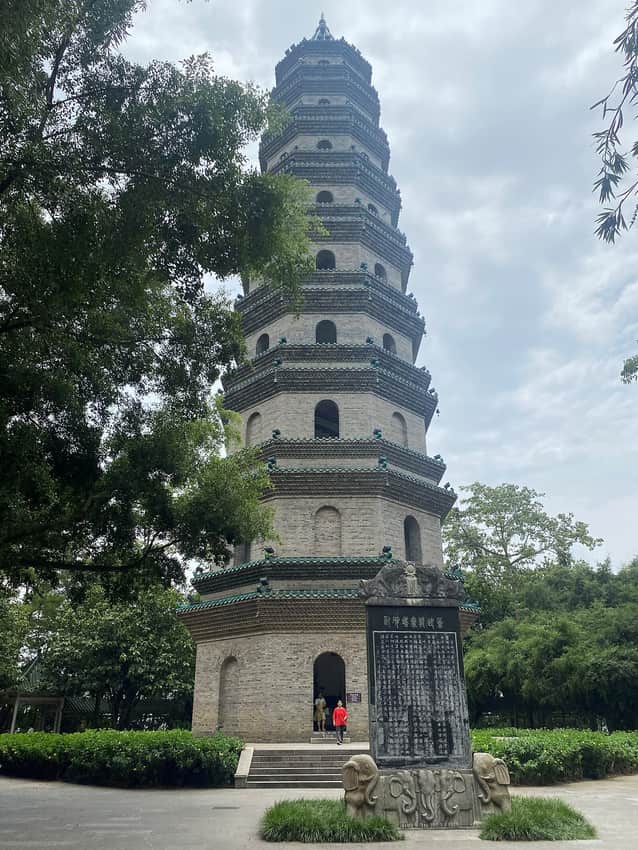 Multi-storey Longxiang Pagoda framed by trees on Qingxiu Mountain