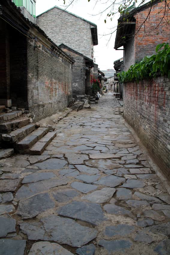 Stone-paved lane between brick buildings in Yangmei