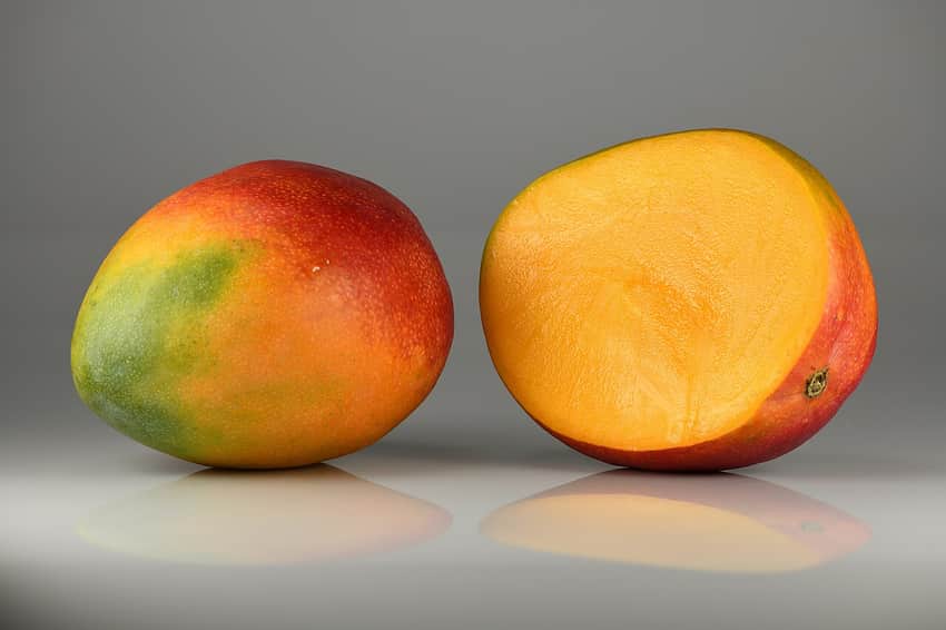 Generic reference photograph of whole and halved mangoes