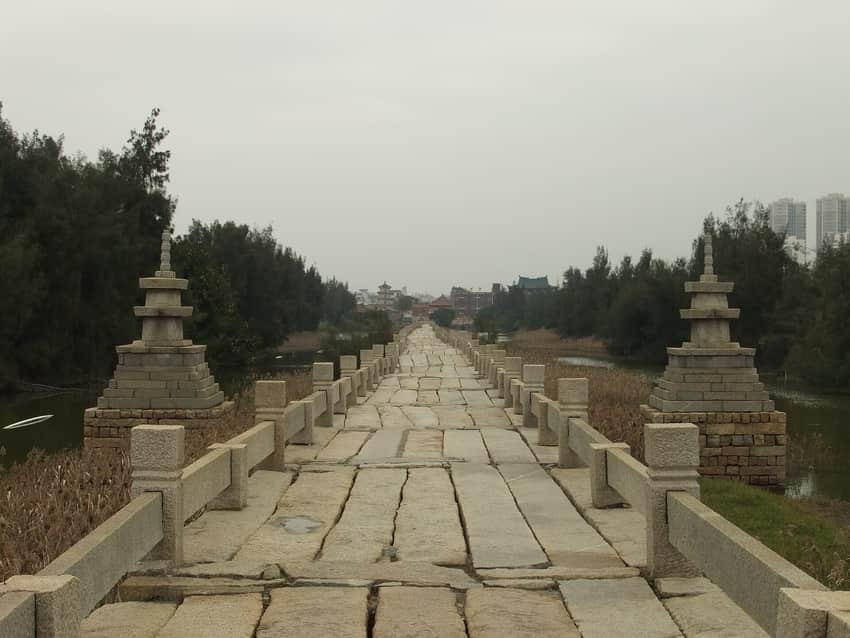 Long straight stone deck, balustrades and small pagodas on Anping Bridge