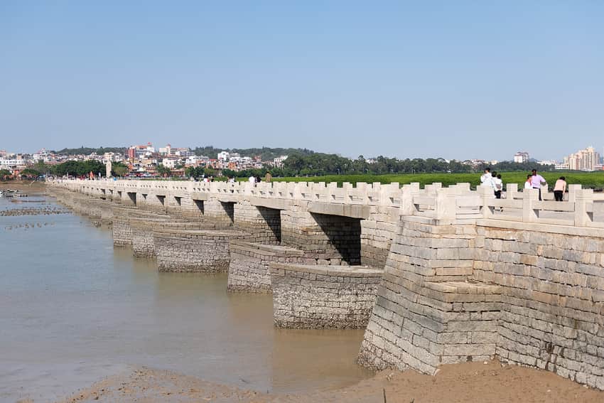 Long stone Luoyang Bridge and piers crossing tidal water and mudflats
