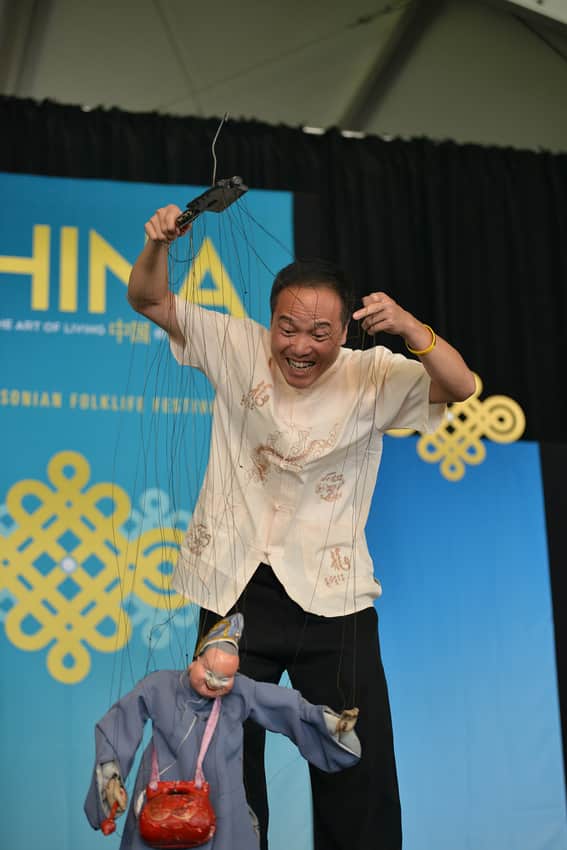 Quanzhou performer operating a string marionette at a 2014 festival