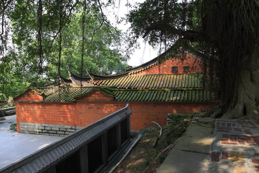 Mossed tile roofs, red walls and a large banyan at Zhenwu Temple