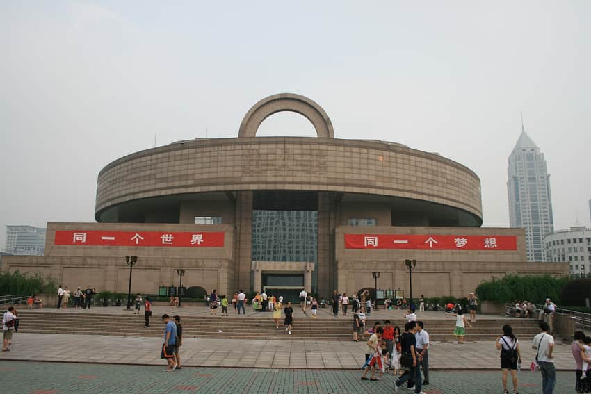 Dated frontal view of Shanghai Museum at People's Square with visitors and temporary banners