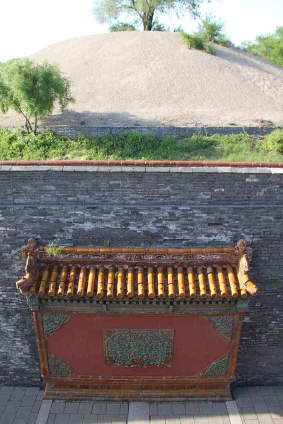 Close view of a tiled wall niche, grey brick and mound at Zhaoling