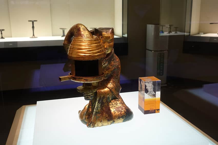 Changxin Palace lamp under museum lighting in a display case