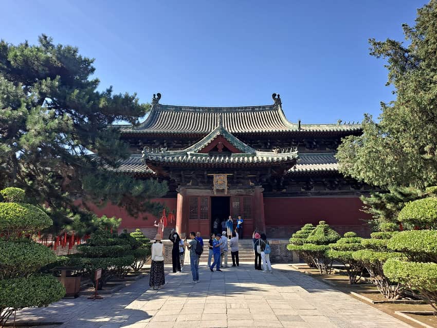 Historic timber hall, roof and visitors at Longxing Temple in Zhengding