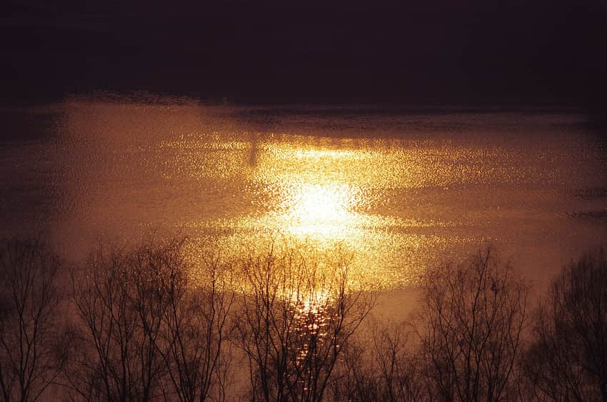 Golden morning light across the Ye River and wooded banks in Pingshan County