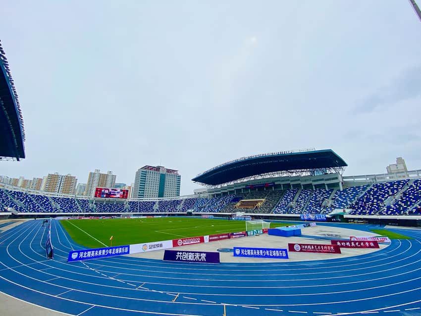 Dated stadium interior with seating, field and event signage