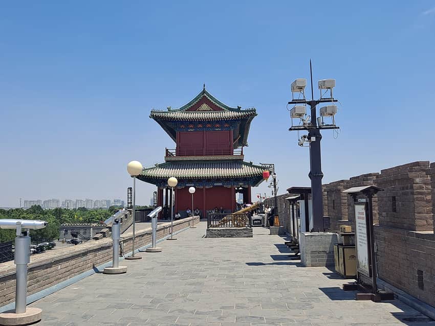Restored Zhengding South Gate deck with visitors and contemporary city beyond