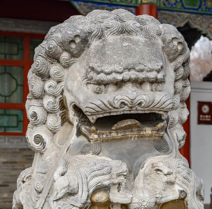 Close view of a weathered stone guardian lion at Jinci