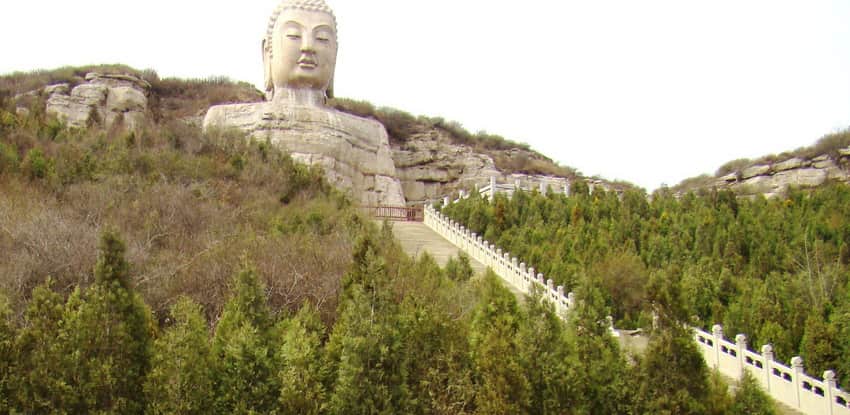 Restored monumental Buddha form and managed mountain landscape at Mengshan