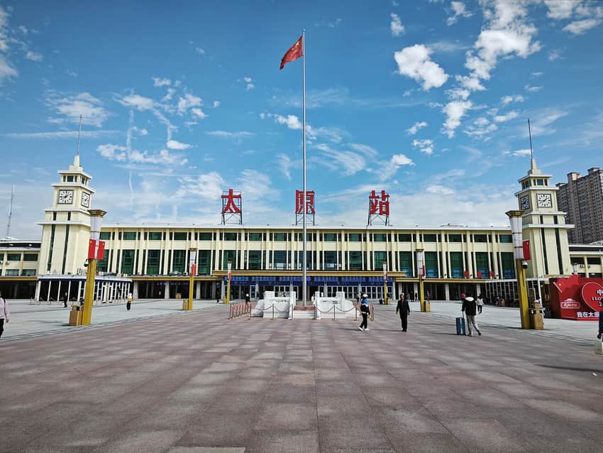 Bright 2025 exterior of Taiyuan Railway Station with forecourt and passengers