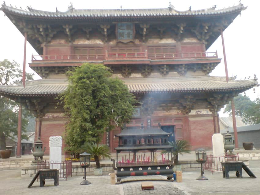 Frontal view of Guanyin Pavilion, incense equipment and trees at Dule Temple