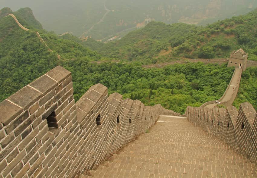 Steep Huangyaguan Great Wall, watchtowers, visitors and wooded mountain ridges