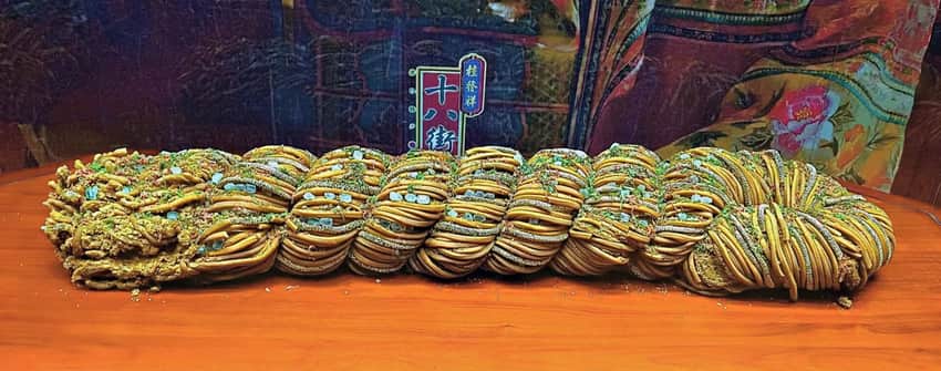 Exceptionally large braided Shibajie mahua displayed in an exhibition case