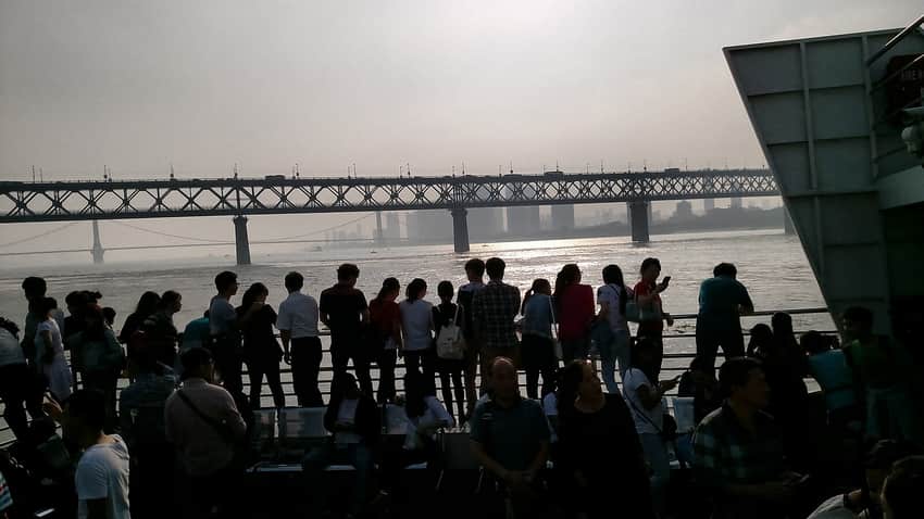 Passengers on a Wuhan ferry with the Yangtze bridge behind