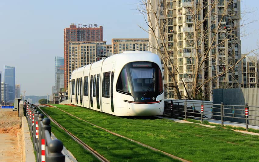Optics Valley modern tram on grass-covered track